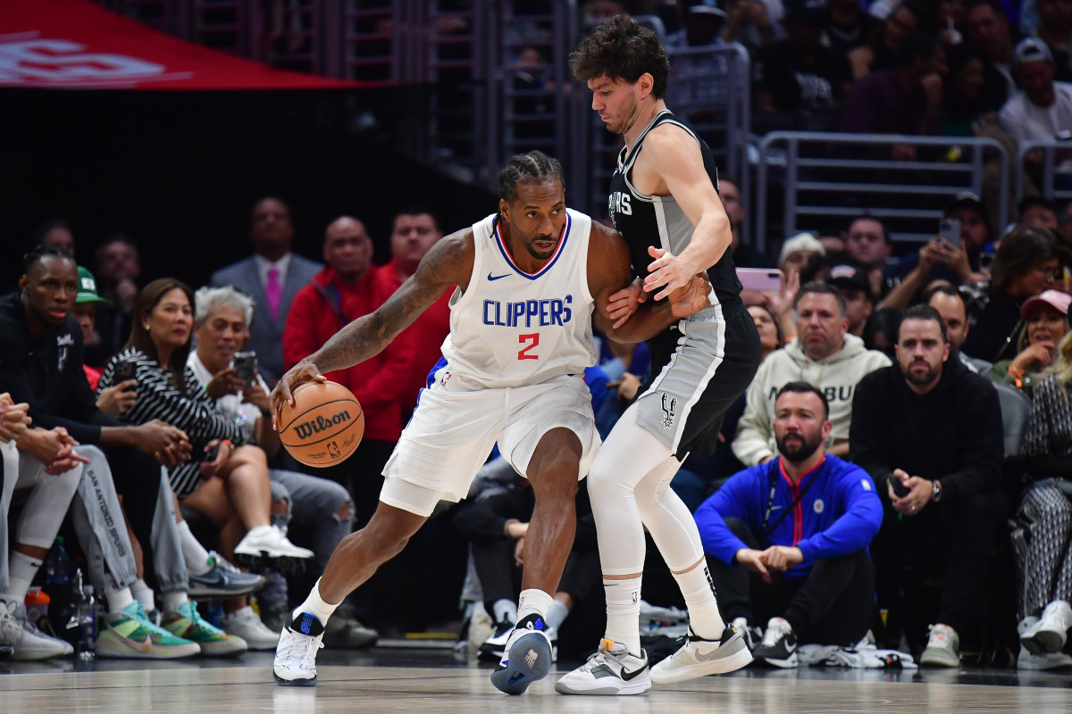 Oct 29, 2023; Los Angeles, California, USA; Los Angeles Clippers forward Kawhi Leonard (2) moves the ball against San Antonio Spurs forward Cedi Osman (16) during the second half at Crypto.com Arena. 